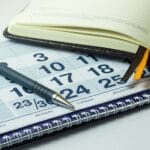 Business notebook on the calendar background