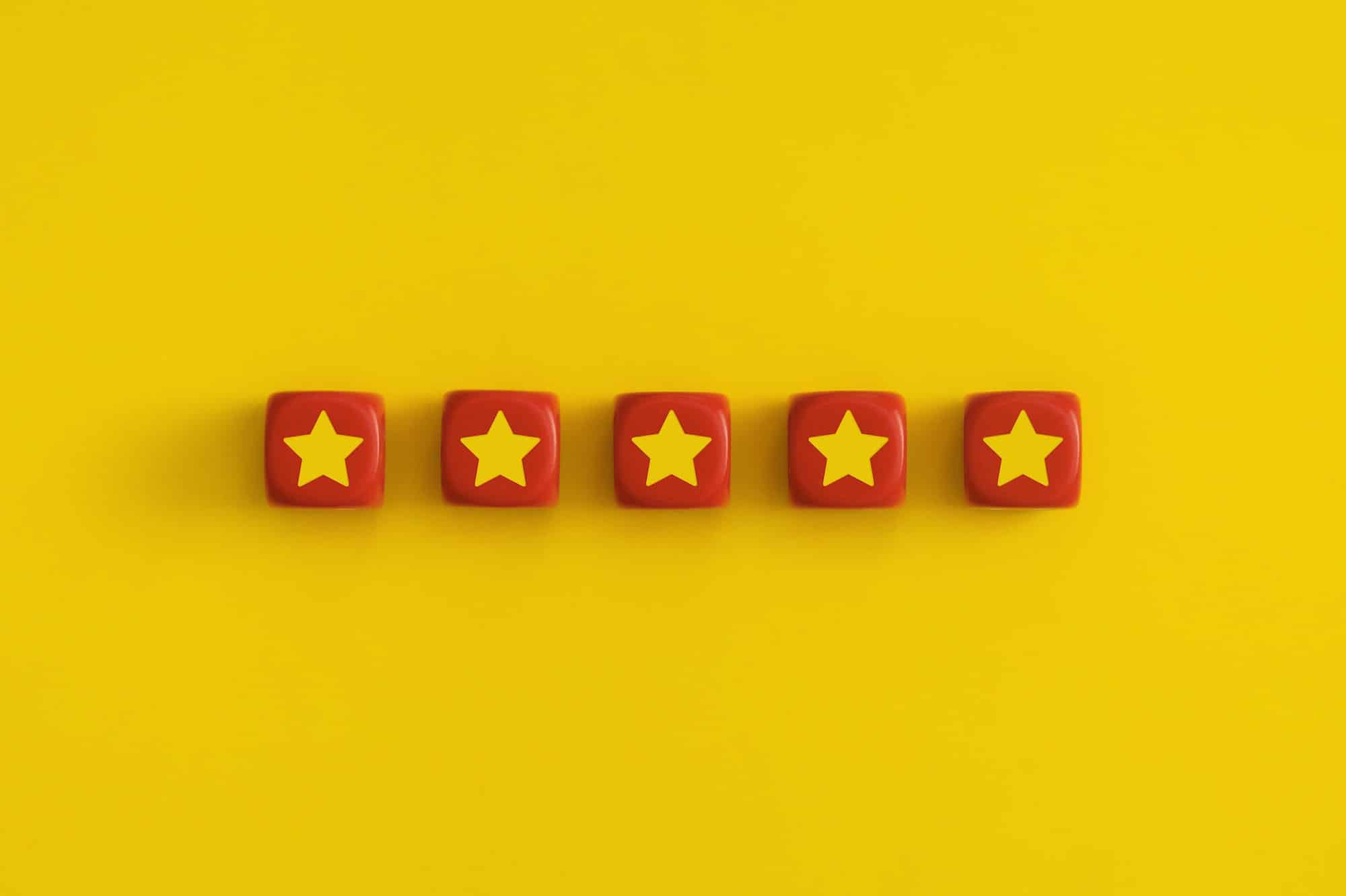 Golden five 5 stars, best excellent services rating on a red cubes