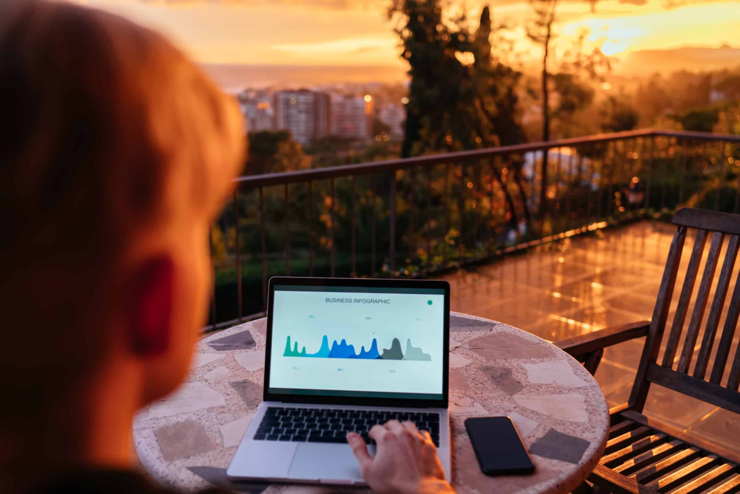Skilled financial expert checking digital marketing report during distance job at sunset