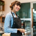 Portrait of happy coffee shop owner welcome greeting customer