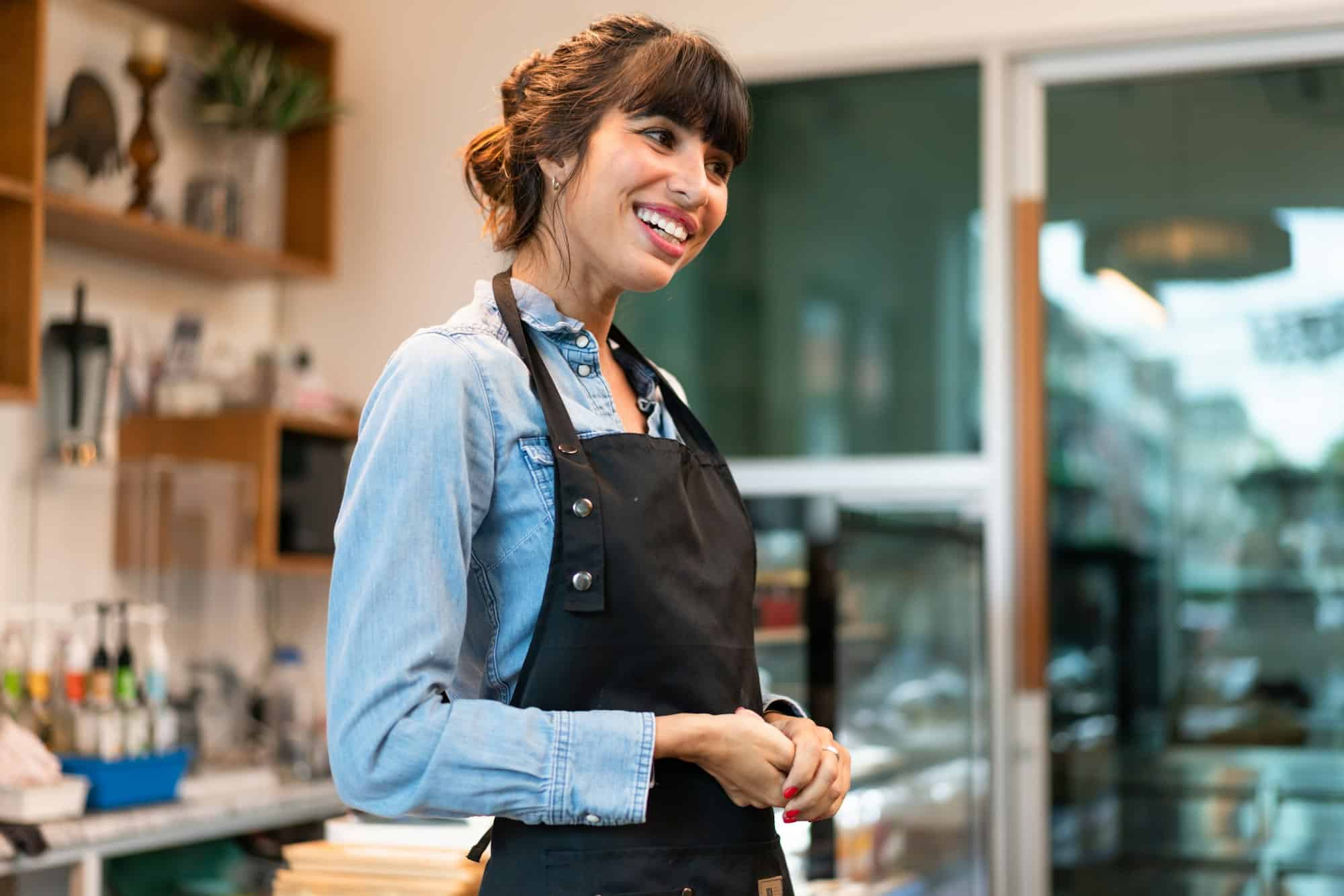Portrait of happy coffee shop owner welcome greeting customer