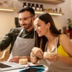 Wife drinking coffee with husband and planning menu