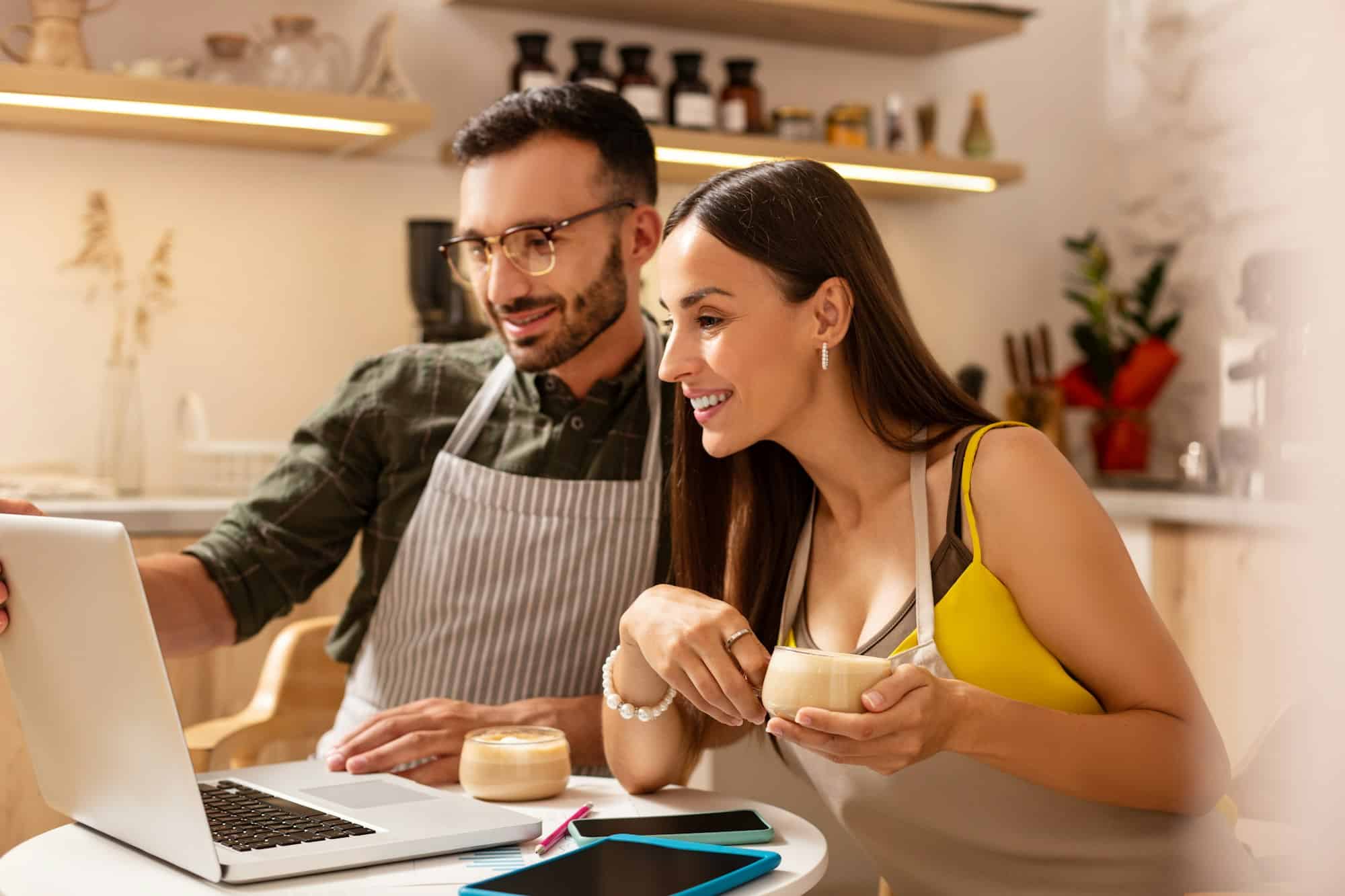 Wife drinking coffee with husband and planning menu